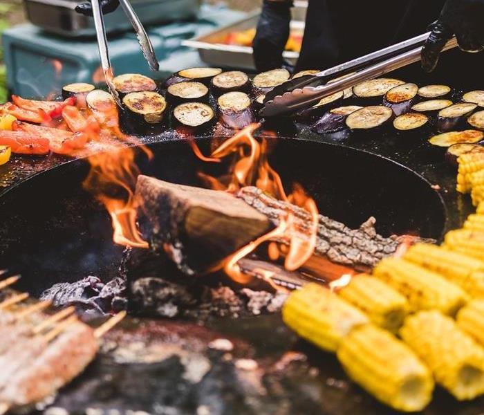 Grill with corn, meats, and peppers